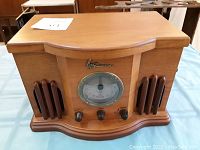 Front view of Emerson radio showing analog tuning dial, control knobs, and speaker grilles.