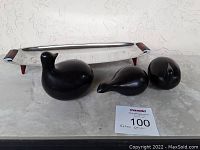 Photo of chrome tray with red Bakelite handles and legs with three wooden bird figurines in front, showing overall set and style.