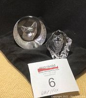 Front view of both the fox and wolf signed crystal glass sculptures showing details and textures.