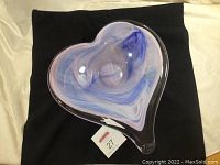 Top angled view of the heart shaped glass bowl showing swirl colors and thickness of glass