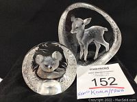 Photo of two signed lead crystal sculptures featuring a koala and a fawn, displayed on a black background with auction lot number visible.