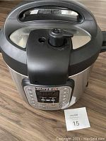 Front view of Instant Pot Duo 6-quart with control panel and lid.