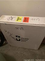 White cardboard box with Clearly Loved Pets logo, handling labels and handwritten lot numbers