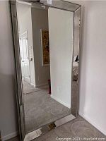 Full view of the mirror leaning against a wall showing overall size and shape