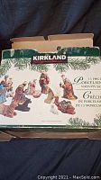 Box featuring Kirkland brand name and illustration of the 13-piece porcelain nativity set