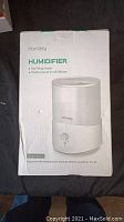 Box front showing image of white Homasy humidifier with model details.