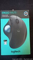 Front of Logitech Ergo M575 mouse box showing the product image and wireless USB receiver.