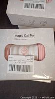 Close-up photo of one boxed Magic Cat Toy showing packaging details and toy color.