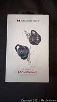 Front of package showing Monster branding and product image of earbuds submerged under water illustrating water resistance.