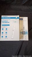 Box of AMIGO Electric Toothbrush Oral Irrigator showing product features and front of ABOX Oral Irrigator box
