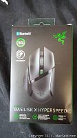 Front of the box showing Razer Basilisk X Hyperspeed mouse, highlighting Bluetooth, 5G hyperspeed wireless connection, mechanical mouse switches, and ultra-long battery life features.