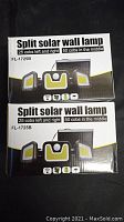 Two boxed split solar wall lamps model FL-1725B with front packaging visible showing the number of COB LEDs per panel.