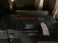 Closed black Bosch hard plastic carrying case with Bosch logo on top.