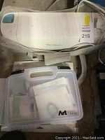 Cricut Explore Air machine in gray tote bag with ArtBin box below
