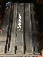 Top view of black Husky tool chest lid with Husky logo visible