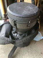 Partial view of drum secured in padded black carry case.