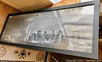 Tall panoramic black and white city skyline print in rectangular frame, 40x15 inches