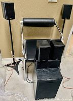 Image showing black leather and chrome chair and Energy 6-piece speaker set with wires.