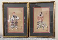 Two framed Chinese art pieces side by side, showing warrior figures in traditional attire, gold bamboo-style frames, double mat in black and red.