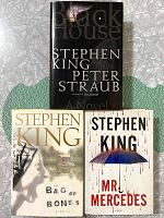 Front covers of 'Black House,' 'Bag of Bones,' and 'Mr. Mercedes' by Stephen King (and Peter Straub co-author on Black House).