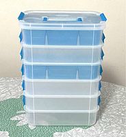 Front view of 6 Sterilite plastic stackable boxes with lids, showing translucent construction with blue locks and handle