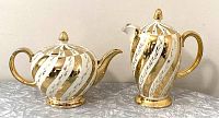 Photo showing both coffee pot and teapot side by side from front angle to display overall shape and design