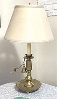 Full view of vintage brass candlestick table lamp with Frederick Cooper fabric shade