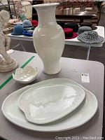 Tall white Italian ceramic vase with prominent crazing on the surface, two white ceramic platters and a small white ceramic candy bowl