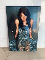 Front view of the Aaliyah wall plaque showing the photographic image of the singer in a blue dress with her name across the middle.