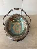 Top-down view of the brides basket showing ornate patterns and copper colored plate interior with tarnish.