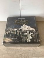 Front view of the sealed Harry Potter Wizard Chess Set box showing the title, chess pieces, and board image.