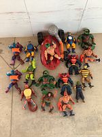 Overview of all He-Man Masters of the Universe characters and vehicle in lot, showing color details and layout