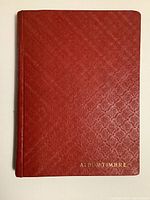 Red hardcover album with gold lettering 'ALBUM TIMBRE' showing full front cover.