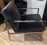Side view showing charcoal velvet seat and back and brass-finished stainless steel frame
