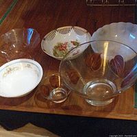Top view of the six bowls showing varying sizes and designs including clear glass and floral ceramic bowls