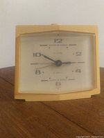 Front view of vintage Allegro wind-up clock showing the clock face, hands, and numerals clearly.