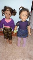 Both American Girl dolls side by side showing full body, clothing, and hairstyles