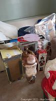 Photo showing plush hide-a-corner reindeer plush figure with antlers, packaging boxes including nutcracker and toy soldier