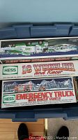 Photo of boxed Hess 18 Wheeler and Racer truck and Emergency Truck with Rescue Vehicle boxes stacked
