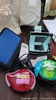 Entire lot displayed including Nintendo DS in case, game cartridges, charger, and earphones on table.