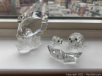 Overall display of fish figurine and seals on ice float, showcasing size and clarity.