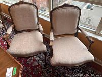Front view of two wooden armchairs side by side