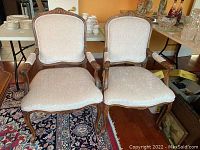 Front view of two beige upholstered chairs side by side