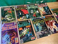 Nine DC The House of Secrets comic books laid out in two rows, showcasing vintage horror-themed cover art from the 1970s.