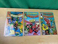 Front cover of all three Spider-Ham comics side by side in protective sleeves.