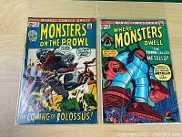 Two Marvel Comics on a flat surface showing full covers side-by-side.