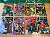 Photo of seven vintage Marvel comics including several Fantastic Four issues and one Marvel's Greatest Comics issue.