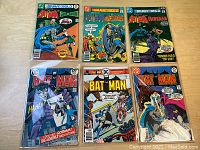 Six comics arranged on tabletop, showing overall lot