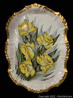 Top-down view of the Limoges dish showing the full hand-painted daffodil bouquet with gold gilded scalloped edges.