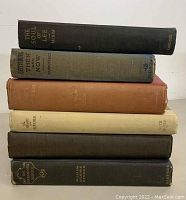 Stack of six antique hardcover books related to the Civil War in various colored cloth bindings, showing titles on the spines.